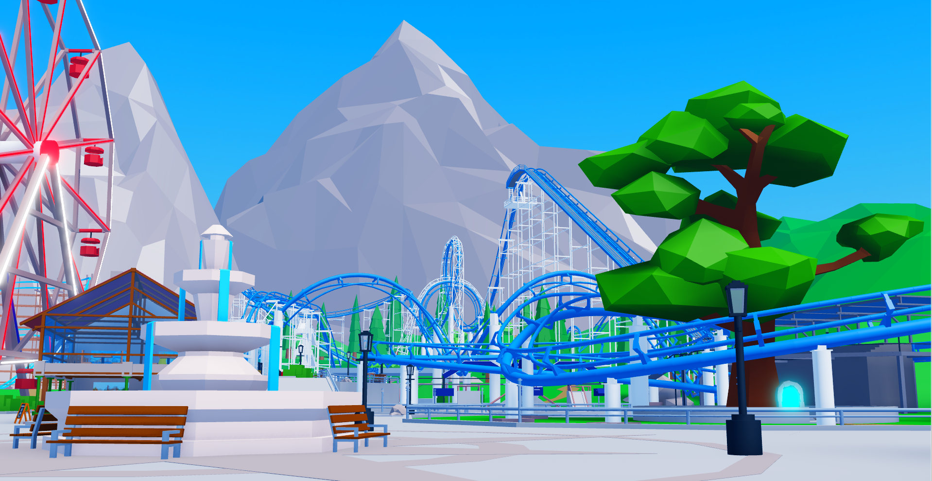 Park square with blue looping roller coaster and mountainous background.